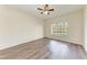 Bright bedroom with wood-look floors and a large window with a view at 6303 Green Oak Cir, Bradenton, FL 34203