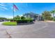 Clubhouse entrance with circular drive and flag at 6303 Green Oak Cir, Bradenton, FL 34203