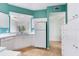 White kitchen with teal walls and ample counter space at 6303 Green Oak Cir, Bradenton, FL 34203