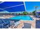 Community pool with lounge chairs and shade umbrellas at 6303 Green Oak Cir, Bradenton, FL 34203
