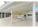 Covered patio area with tables and chairs near the pool at 6303 Green Oak Cir, Bradenton, FL 34203