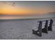 Empty bench on sandy beach at sunset at 706 Hickory Dr, Dunedin, FL 34698