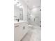 Modern bathroom with white vanity, marble floors, and glass shower at 716 S Lois Ave, Tampa, FL 33609