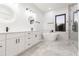 Modern bathroom with double vanity, soaking tub, and walk-in shower at 716 S Lois Ave, Tampa, FL 33609