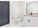 Modern bathroom with white cabinets, and a large mirror at 716 S Lois Ave, Tampa, FL 33609