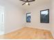 Bright bedroom with hardwood floors, ceiling fan, and access to a private balcony at 716 S Lois Ave, Tampa, FL 33609
