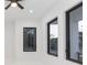 Bright bedroom with white walls, ceiling fan, and large windows at 716 S Lois Ave, Tampa, FL 33609