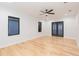 Spacious bedroom with hardwood floors, ceiling fan and private balcony at 716 S Lois Ave, Tampa, FL 33609