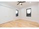 Light and airy bedroom with hardwood floors and white closet doors at 716 S Lois Ave, Tampa, FL 33609