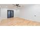 Bright bedroom with hardwood floors, ceiling fan, and balcony access at 716 S Lois Ave, Tampa, FL 33609