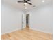 Simple bedroom with hardwood floors and an open doorway at 716 S Lois Ave, Tampa, FL 33609