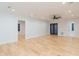 Large bonus room with hardwood floors, ceiling fan and doors to exterior at 716 S Lois Ave, Tampa, FL 33609