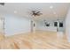 Spacious bonus room with light hardwood floors and ceiling fan at 716 S Lois Ave, Tampa, FL 33609