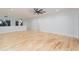 Bonus room with hardwood floors, ceiling fan, and access to a balcony at 716 S Lois Ave, Tampa, FL 33609