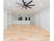 Bright bonus room featuring hardwood floors and a ceiling fan at 716 S Lois Ave, Tampa, FL 33609