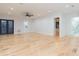 Spacious bonus room with hardwood floors, and access to bathroom and kitchenette at 716 S Lois Ave, Tampa, FL 33609