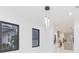 Modern dining room with chandelier and view into the kitchen at 716 S Lois Ave, Tampa, FL 33609