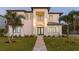 Two-story modern home with a sleek design, landscaped lawn, and walkway at 716 S Lois Ave, Tampa, FL 33609