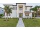 Modern two-story home with a landscaped lawn and walkway at 716 S Lois Ave, Tampa, FL 33609