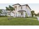 Modern two-story home with palm trees and walkway at 716 S Lois Ave, Tampa, FL 33609