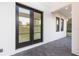 Modern front entrance with black double doors and stone flooring at 716 S Lois Ave, Tampa, FL 33609