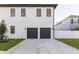 Modern two-car garage with paver driveway at 716 S Lois Ave, Tampa, FL 33609