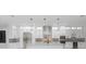 Modern white kitchen with stainless steel appliances and marble flooring at 716 S Lois Ave, Tampa, FL 33609