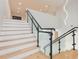 Modern staircase with glass and metal railings leading to the upper level at 716 S Lois Ave, Tampa, FL 33609