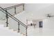 Modern glass and metal staircase with light wood steps at 716 S Lois Ave, Tampa, FL 33609