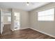 Bedroom with wood-look floors, en-suite bathroom access, and ceiling fan at 7865 38Th N Pl, St Petersburg, FL 33709