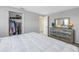 Bright bedroom with a dresser and a view into another room at 811 Camellia Ave, Ellenton, FL 34222