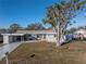 Ranch-style home with carport and mature tree at 811 Camellia Ave, Ellenton, FL 34222