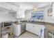 Clean and efficient kitchen with white cabinets and granite countertops at 811 Camellia Ave, Ellenton, FL 34222