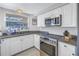 Updated kitchen, featuring stainless steel appliances and granite countertops at 811 Camellia Ave, Ellenton, FL 34222