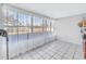 Sunroom with tiled floor, sheer curtains, and view of backyard at 811 Camellia Ave, Ellenton, FL 34222