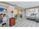 Sunroom with tiled floor, treadmill, and access to the kitchen at 811 Camellia Ave, Ellenton, FL 34222