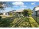 Spacious backyard with patio, lush landscaping, and fenced enclosure at 8442 Lagerfeld Dr, Land O Lakes, FL 34637