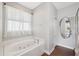 Relaxing bathroom with soaking tub and updated flooring at 8442 Lagerfeld Dr, Land O Lakes, FL 34637