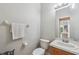 Clean and simple half bathroom with a single sink and toilet at 8442 Lagerfeld Dr, Land O Lakes, FL 34637