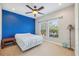 Serene bedroom with blue accent wall and ceiling fan at 8442 Lagerfeld Dr, Land O Lakes, FL 34637