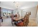 Spacious dining area with a large table and chandelier at 8442 Lagerfeld Dr, Land O Lakes, FL 34637