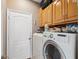 Laundry room with washer, dryer, and storage cabinets at 8442 Lagerfeld Dr, Land O Lakes, FL 34637