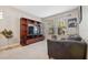 Living room with a large TV stand, leather couch, and large windows at 8442 Lagerfeld Dr, Land O Lakes, FL 34637