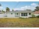 Home features a backyard with grassy area and patio at 956 Bruce Ave, Clearwater Beach, FL 33767