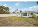 Large backyard with grassy area and white fence at 956 Bruce Ave, Clearwater Beach, FL 33767