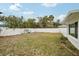 Backyard with grassy area and partial home view at 956 Bruce Ave, Clearwater Beach, FL 33767