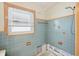Shower stall with blue tile and decorative accents at 956 Bruce Ave, Clearwater Beach, FL 33767