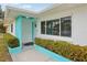 Front entrance with teal accents and landscaping at 956 Bruce Ave, Clearwater Beach, FL 33767