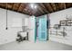 Garage with a small bathroom and storage shelves at 956 Bruce Ave, Clearwater Beach, FL 33767