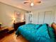 Comfortable bedroom with teal bedding, wood floors and dresser at 2043 Denmark St # 57, Clearwater, FL 33763